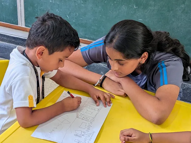 A volunteer providing individual support to a student