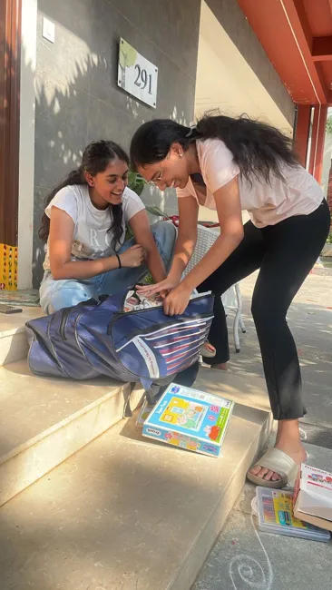 Volunteers sharing books and activity materials at the orphanage