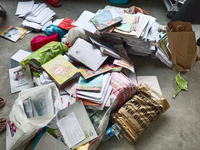 Piles of donated books and newspapers ready for recycling